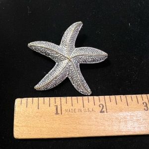 Starfish pin/necklace slide done in silver metal with gold accents